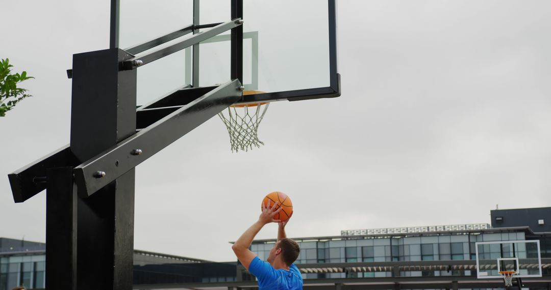 Man Playing Basketball Outdoor Showing Slam Dunk - Free Images, Stock Photos and Pictures on Pikwizard.com