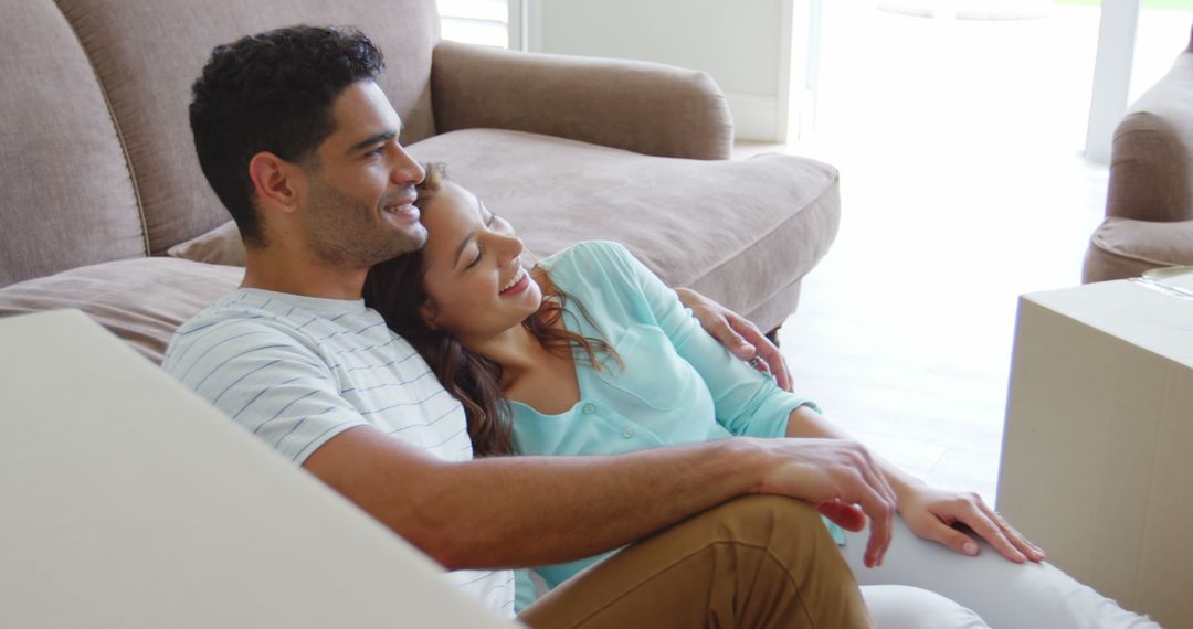Happy Couple Sitting in Living Room After Moving In