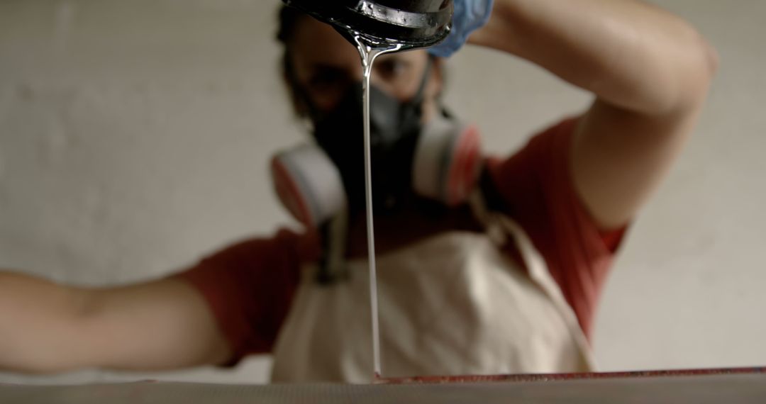 Person Pours Liquid While Wearing Protective Gear - Free Images, Stock Photos and Pictures on Pikwizard.com