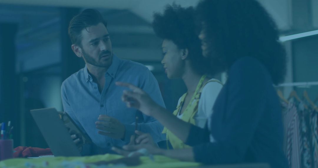 Creative Team Collaborating in Design Studio with Tablet and Swatches