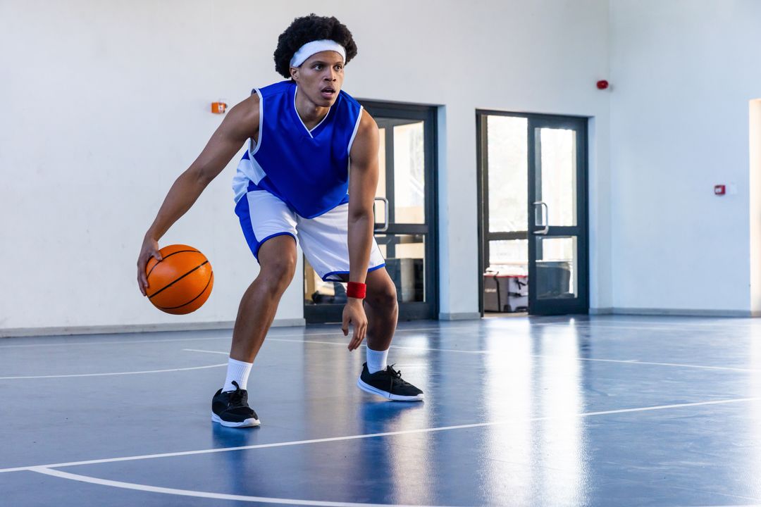 Dynamic Basketball Player Dribbling on Indoor Court