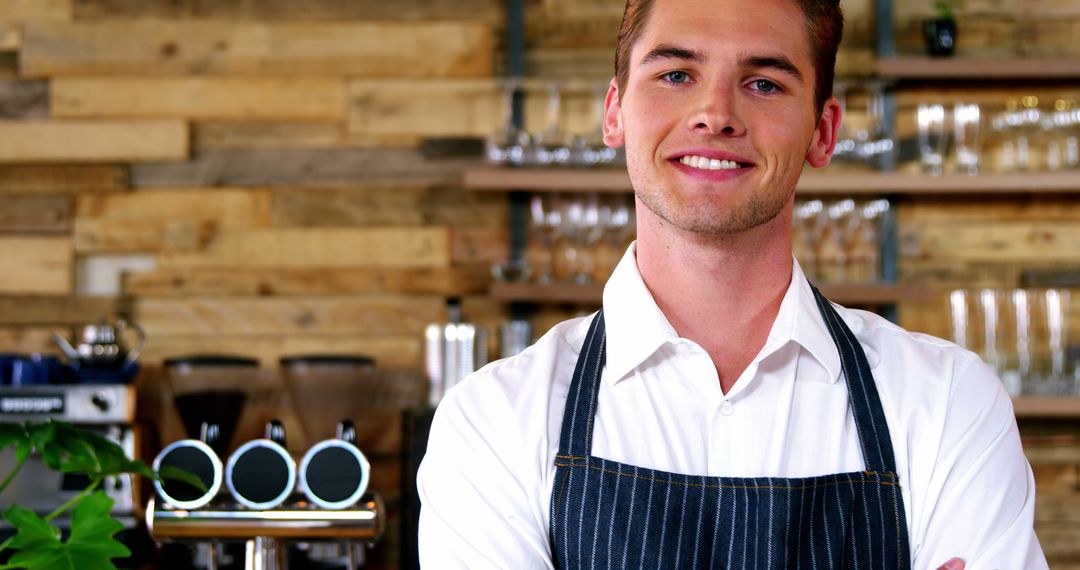 Smiling Waiter in Apron Standing in Rustic Cafe Environment