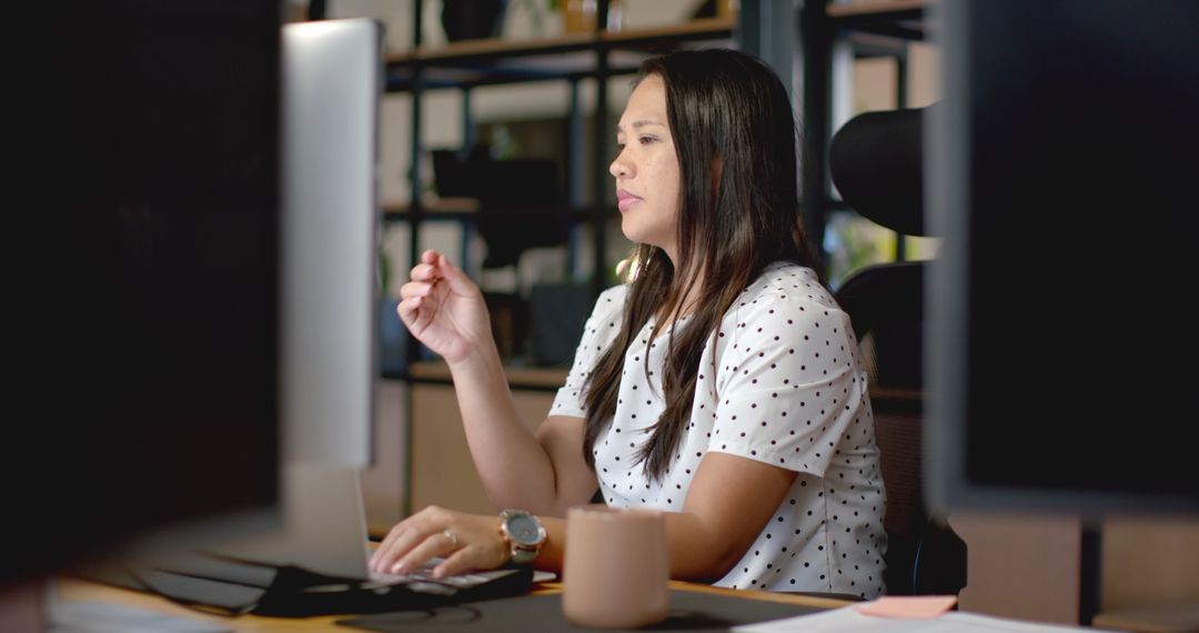 Focused Businesswoman Using Computer at Office Desk