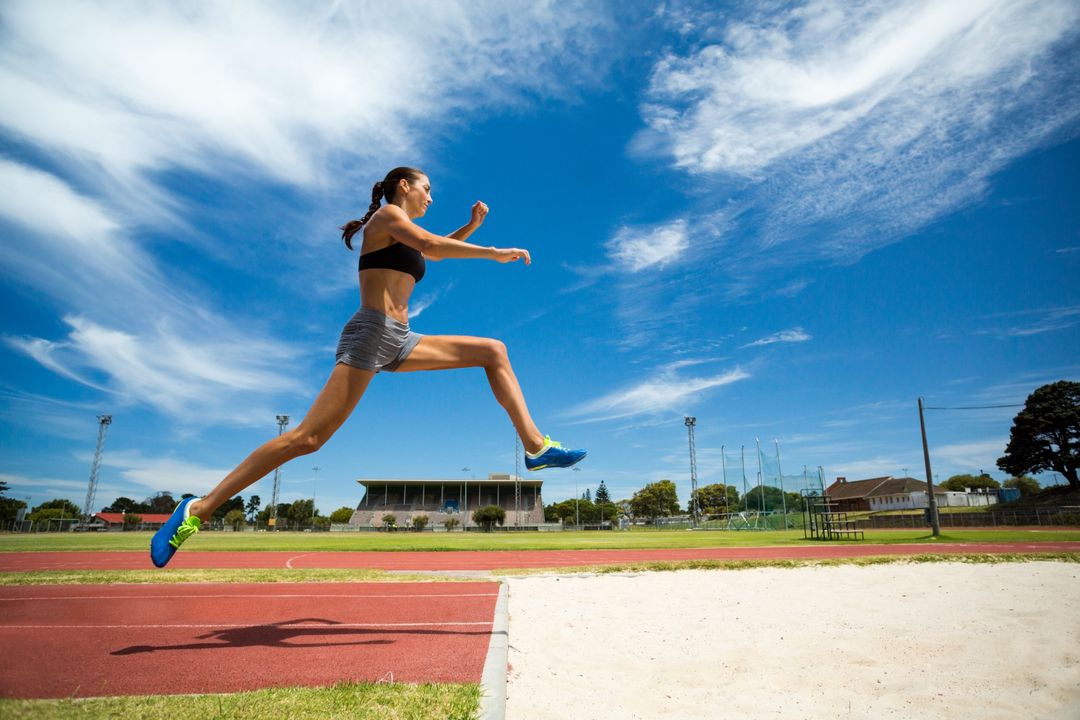 Female athlete performing a long jump - Free Images, Stock Photos and Pictures on Pikwizard.com
