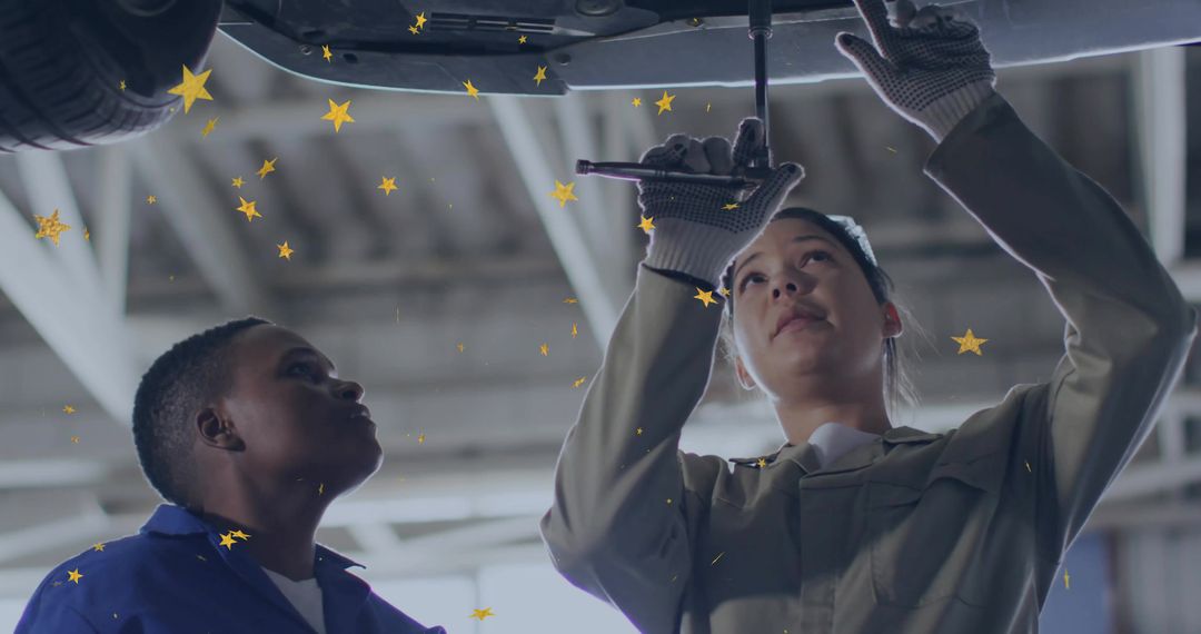 Mechanics Collaborating to Repair Vehicle in Auto Shop Garage