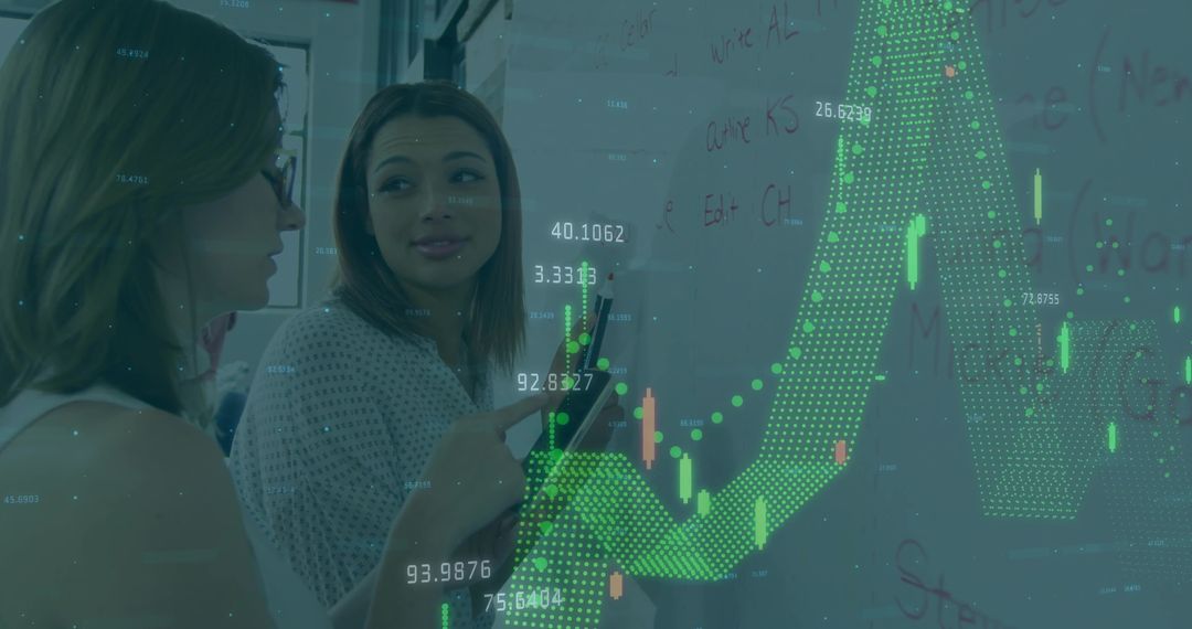 Female Colleagues Analyzing Financial Chart on Whiteboard