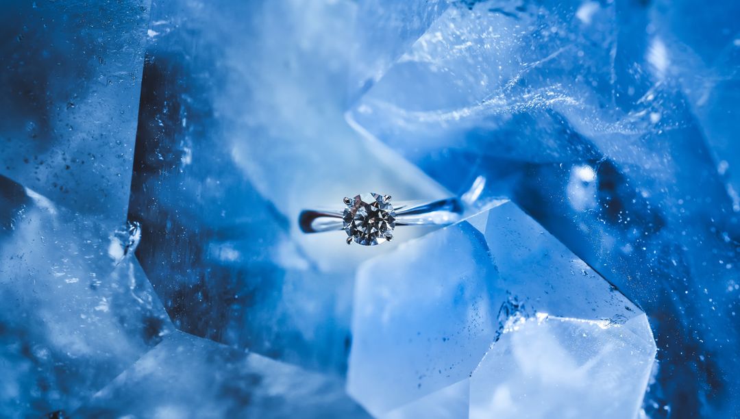 Elegant Solitaire Diamond Ring on Blue Crystal Surface