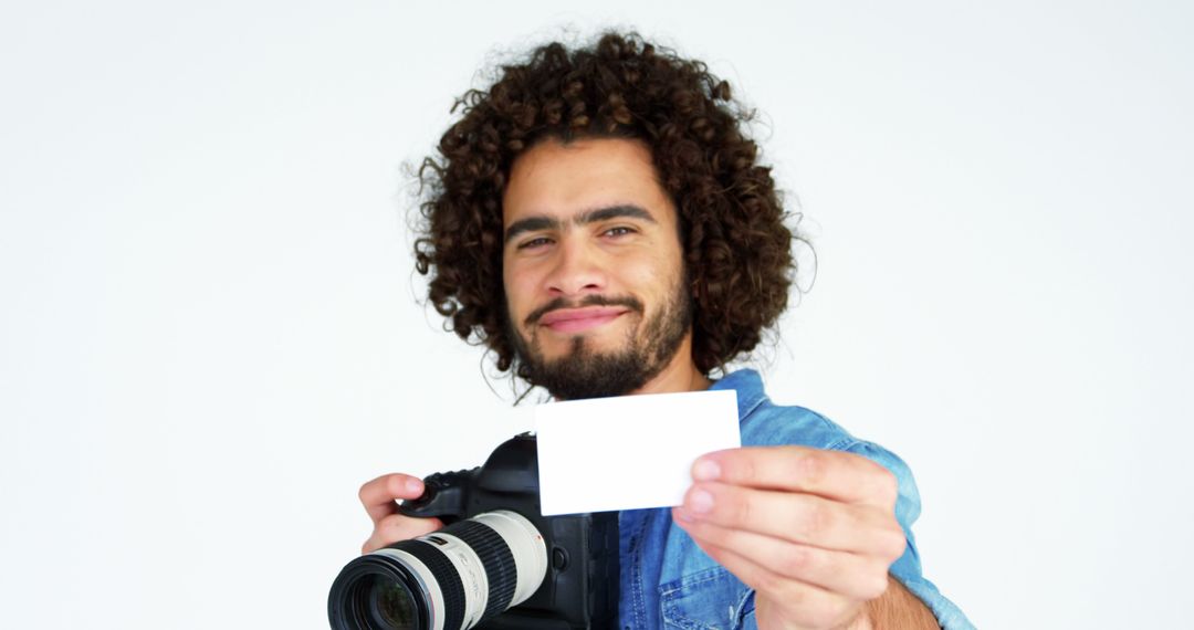 Male Photographer Holding White Card and Camera - Free Images, Stock Photos and Pictures on Pikwizard.com