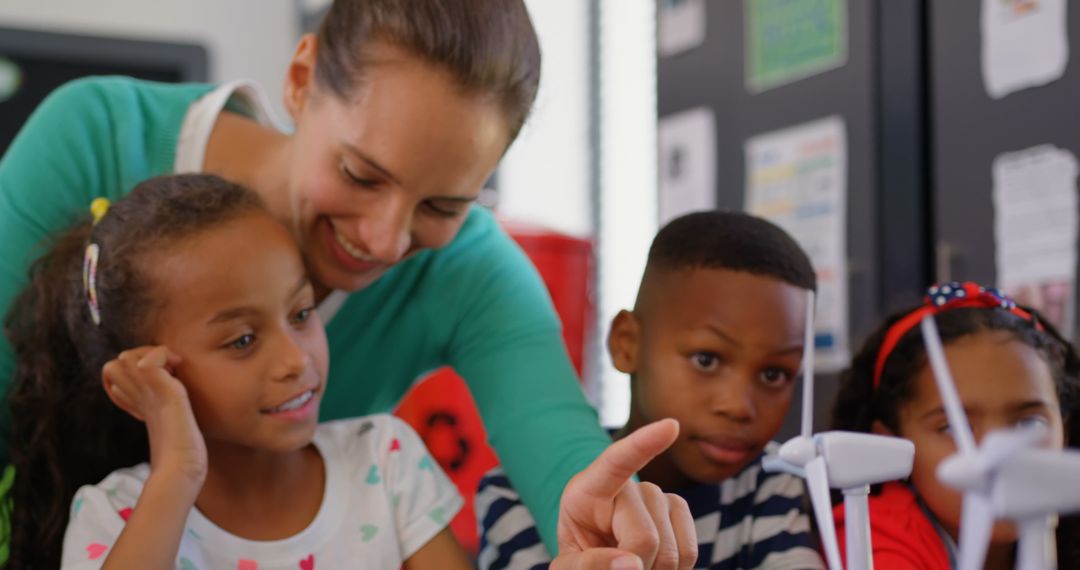 Teacher Engaging Students with Interactive Windmill Model in Classroom