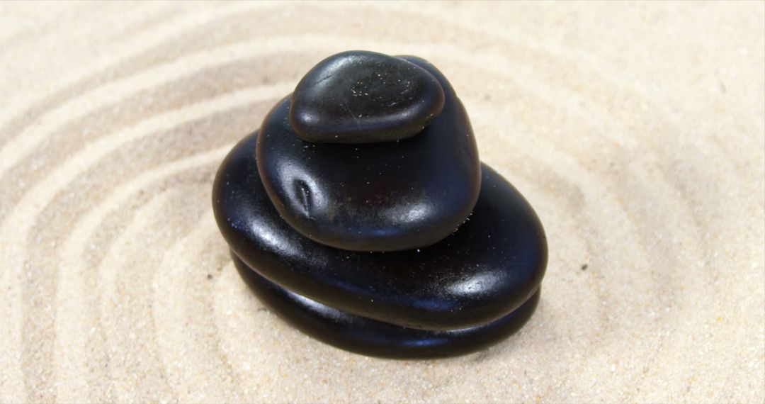 A serene arrangement of black stones on sand symbolizes tranquility and mindfulness. - Free Images, Stock Photos and Pictures on Pikwizard.com