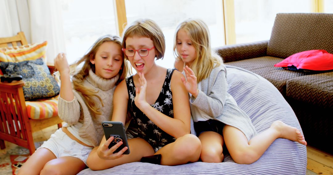 Three Sisters Video Chatting on Smartphone in Cozy Living Room - Free Images, Stock Photos and Pictures on Pikwizard.com