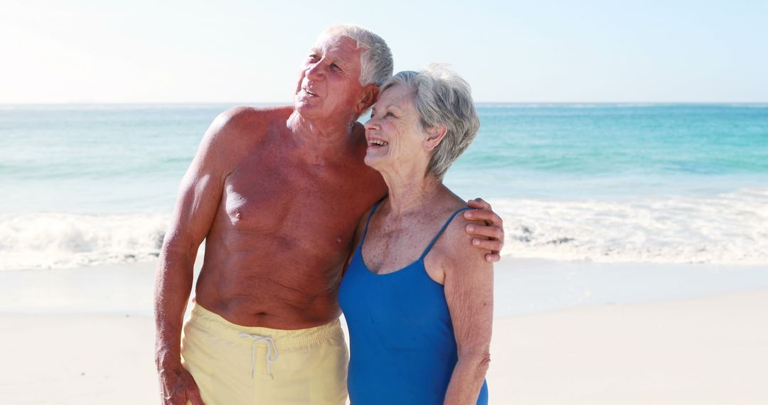 Senior Couple Enjoys Beach Vacation Embracing on Shoreline - Free Images, Stock Photos and Pictures on Pikwizard.com