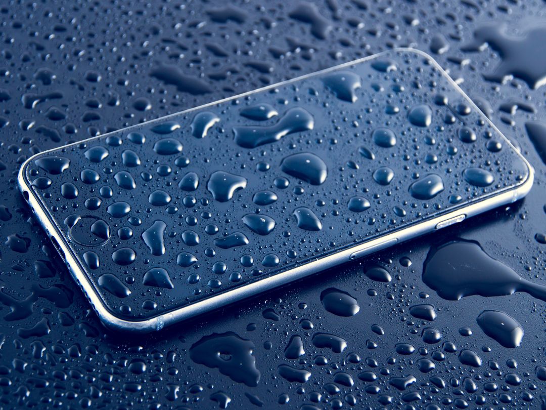 Smartphone Covered in Water Drops on Dark Surface - Free Images, Stock Photos and Pictures on Pikwizard.com
