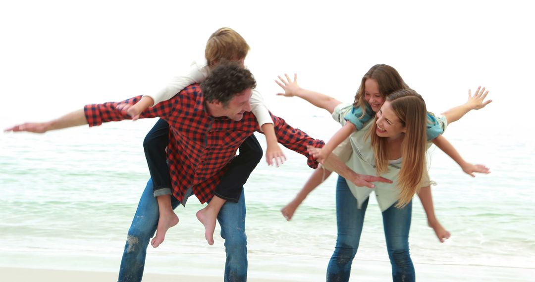 Happy Family Playing on Beach, Parents Giving Piggyback Rides To Children - Free Images, Stock Photos and Pictures on Pikwizard.com