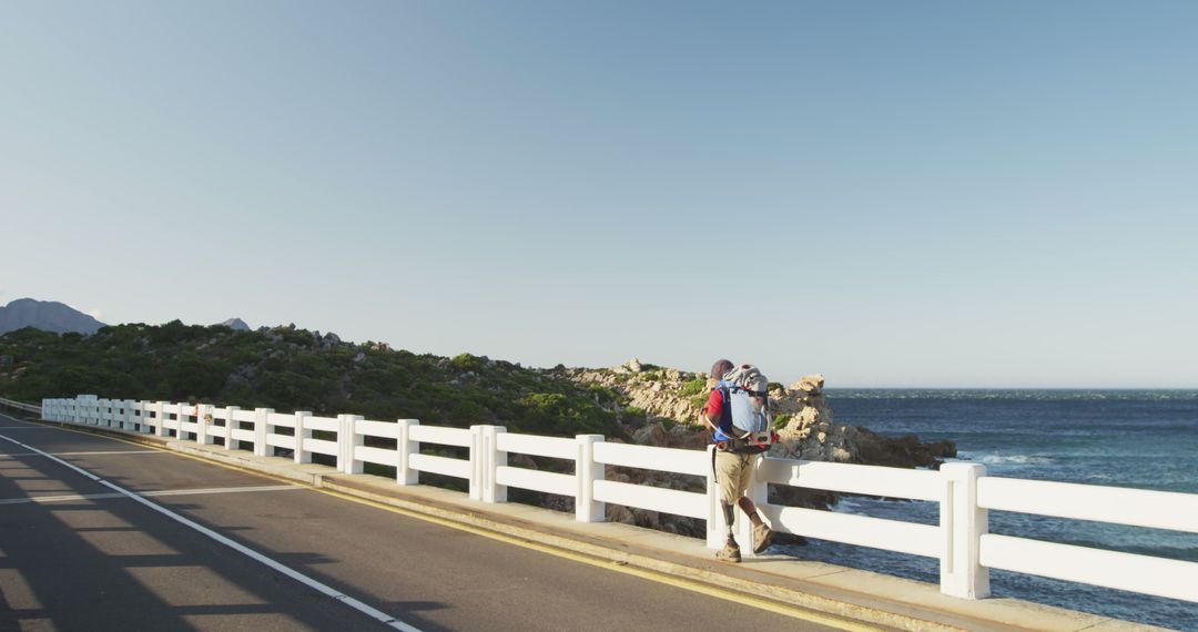 Man with Prosthetic Leg Trekking by Ocean Bridge