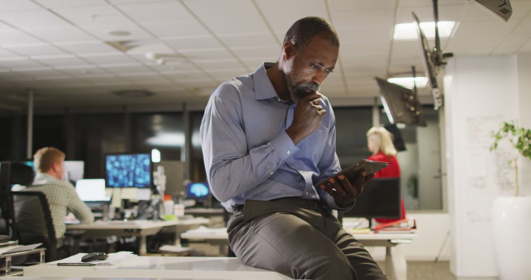 Pensive African-American Businessman Working Late in Office - Free Images, Stock Photos and Pictures on Pikwizard.com