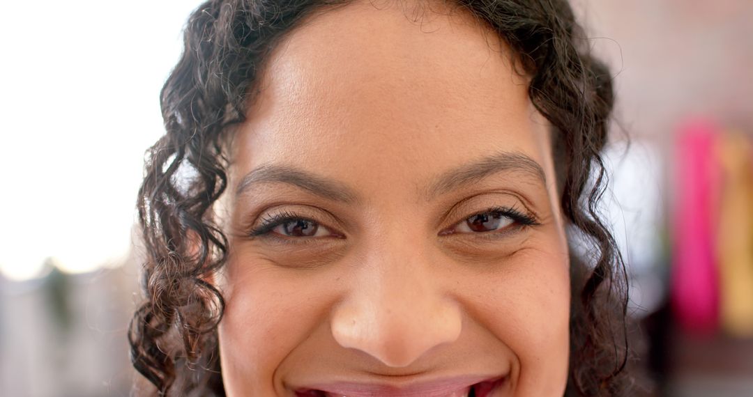 Close-up Smiling Woman Showing Joy with Natural Curly Hair - Free Images, Stock Photos and Pictures on Pikwizard.com