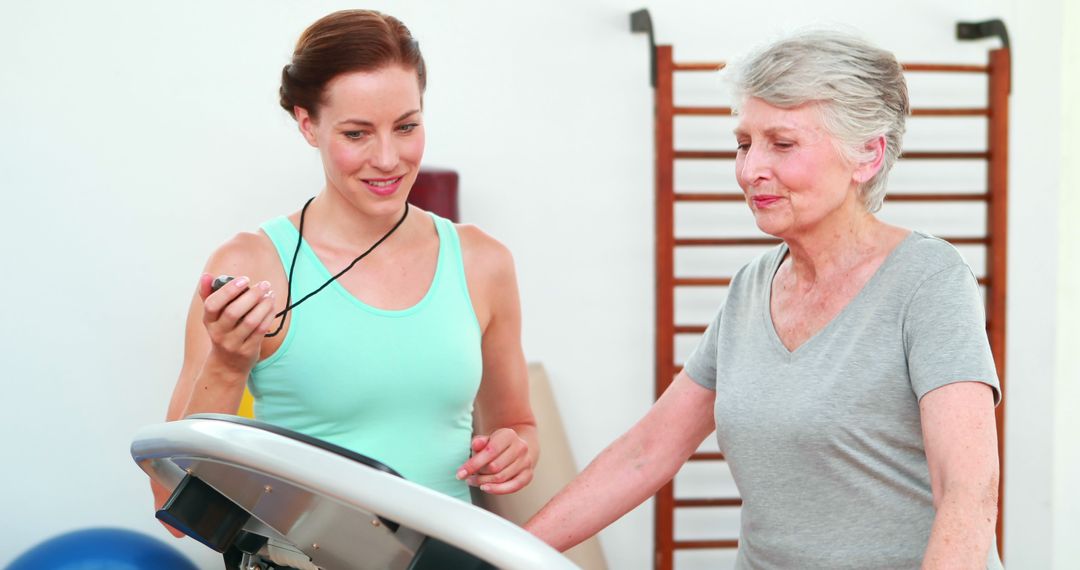 Personal Trainer Supervising Senior Woman on Treadmill - Free Images, Stock Photos and Pictures on Pikwizard.com