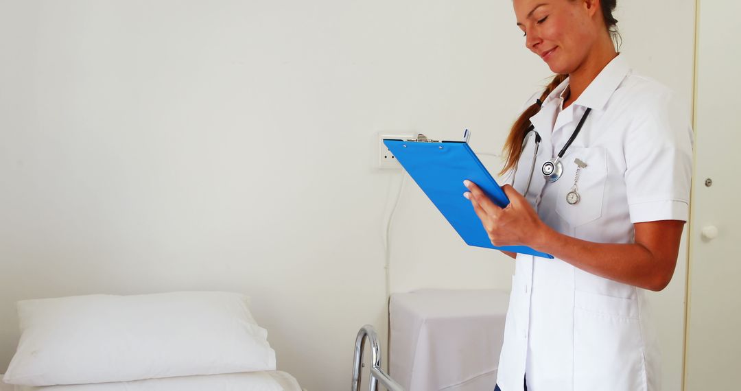 Smiling Nurse Writing on Clipboard in Hospital Room - Free Images, Stock Photos and Pictures on Pikwizard.com