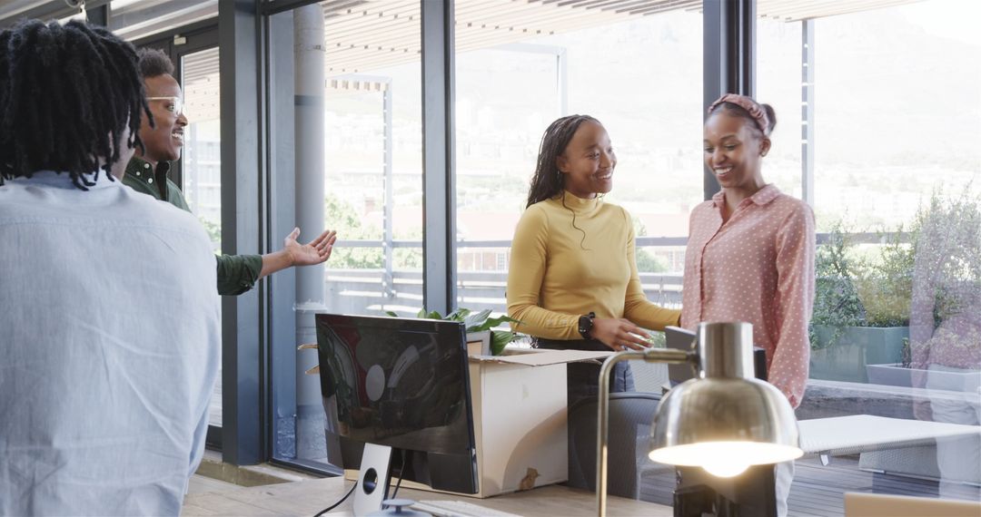Diverse Colleagues Unpacking Box in Office Smiling