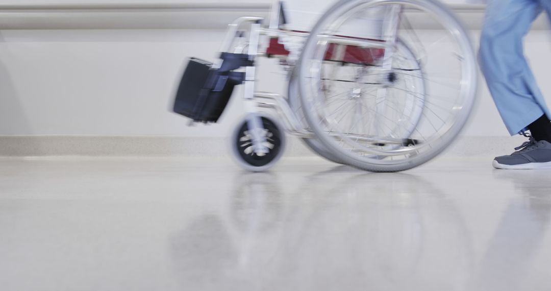 Hospital Staff Wheeling Empty Wheelchair Through Corridor - Free Images, Stock Photos and Pictures on Pikwizard.com