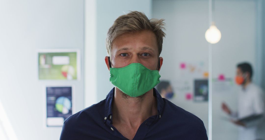 Businessman Wearing Green Face Mask in Modern Office - Free Images, Stock Photos and Pictures on Pikwizard.com