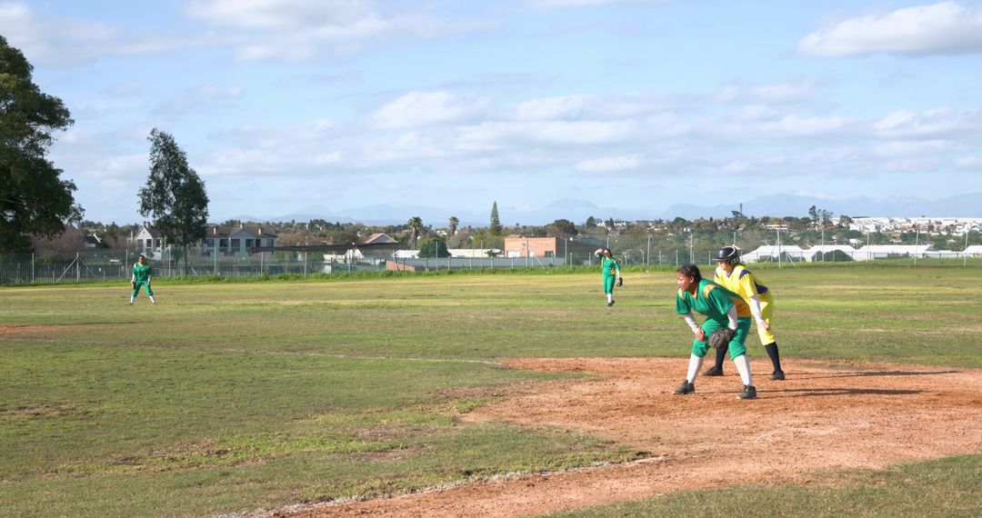 Female Softball Players Crouching on Field in Athletic Stance
