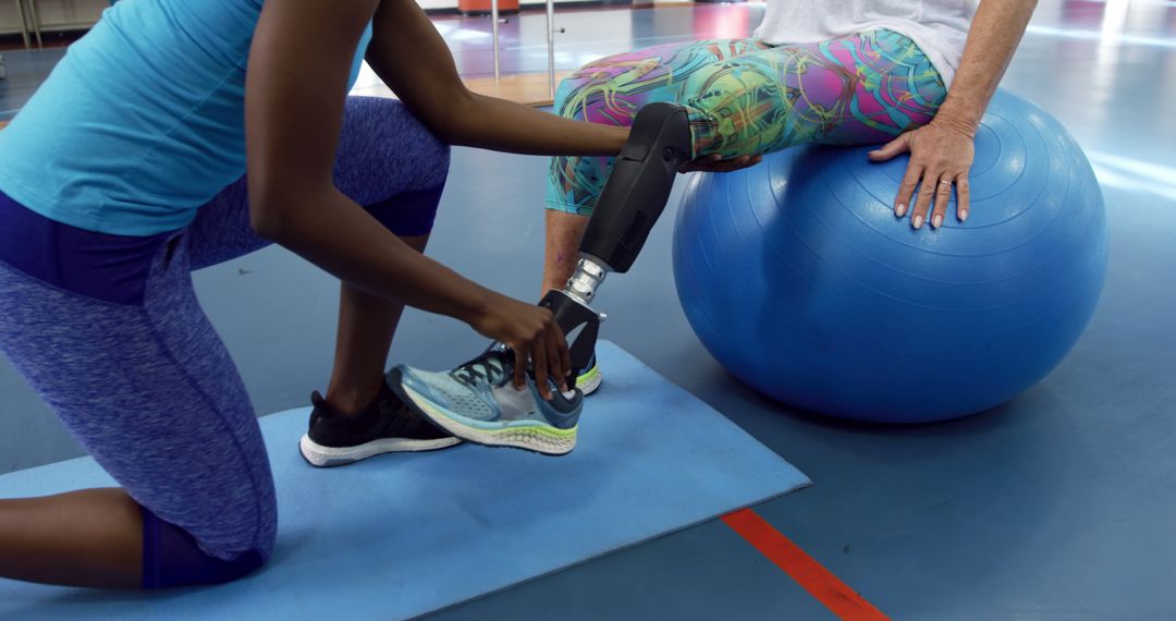 Physical Therapist Assisting Patient with Prosthetic Leg During Rehabilitation - Free Images, Stock Photos and Pictures on Pikwizard.com