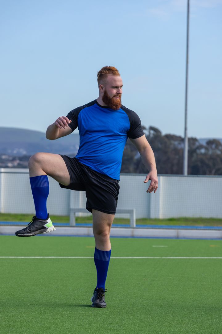 Athlete Balancing on Synthetic Field in Outdoor Training Session