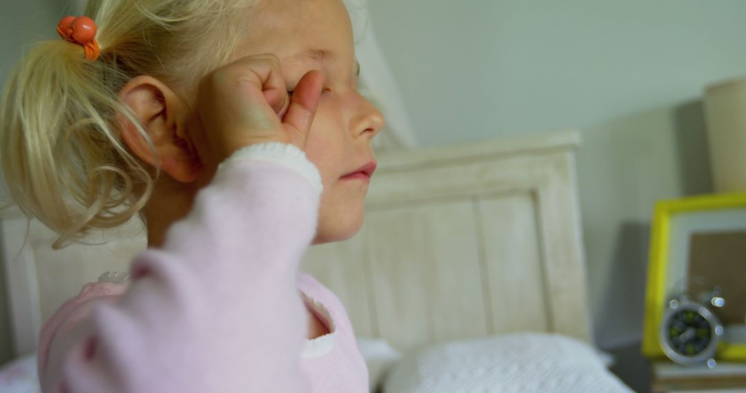 Young Girl Rubbing Eye, Feeling Sleepy or Unwell in Bedroom - Free Images, Stock Photos and Pictures on Pikwizard.com