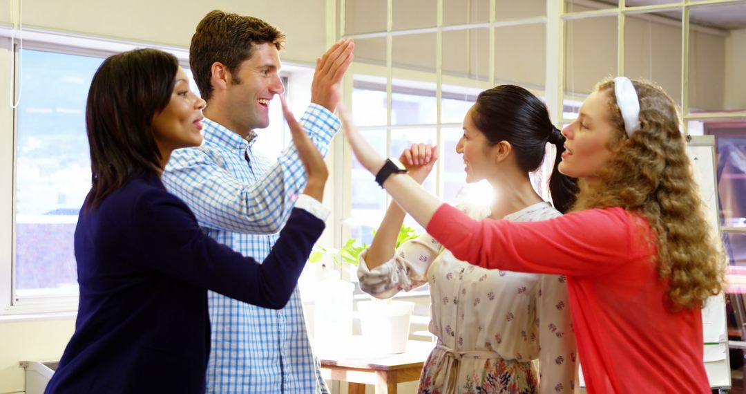 Diverse Team Celebrating Success with High-Fives in Office - Free Images, Stock Photos and Pictures on Pikwizard.com