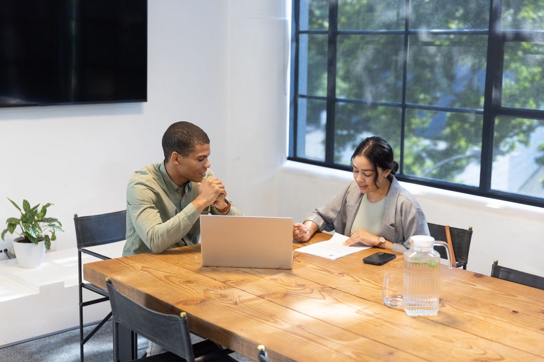 Diverse Coworkers Collaborating at Modern Office Meeting Table
