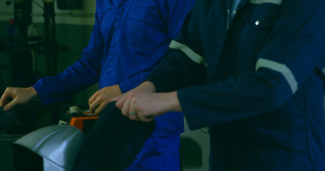 Industrial Workers Preparing Welding Helmets in Workshop - Free Images, Stock Photos and Pictures on Pikwizard.com