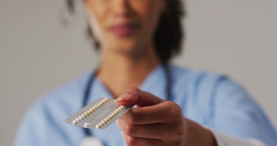 Healthcare Professional Holding Pill Pack Blurred Background - Free Images, Stock Photos and Pictures on Pikwizard.com