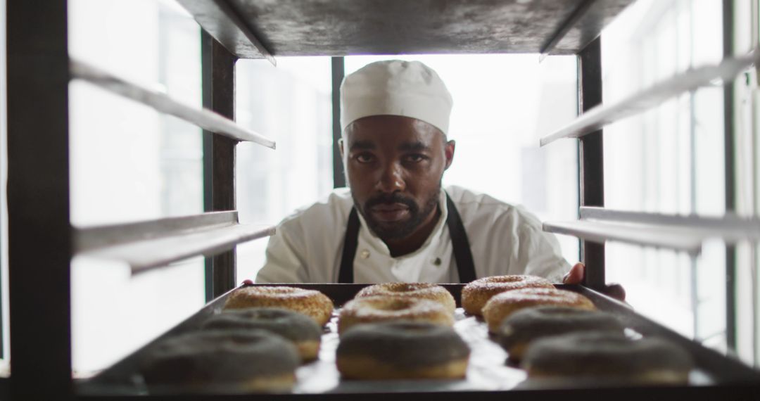 Chef Inspecting Freshly Baked Donuts on Tray - Free Images, Stock Photos and Pictures on Pikwizard.com