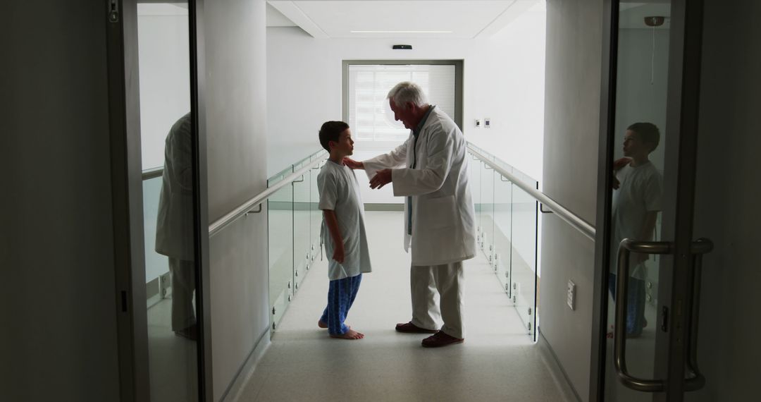 Doctor Consulting with Child Patient in Hospital Hallway - Free Images, Stock Photos and Pictures on Pikwizard.com