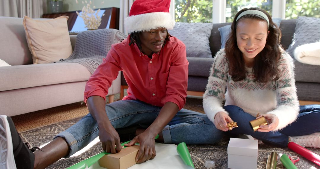 Smiling Friends Wrapping Christmas Gifts Together - Free Images, Stock Photos and Pictures on Pikwizard.com