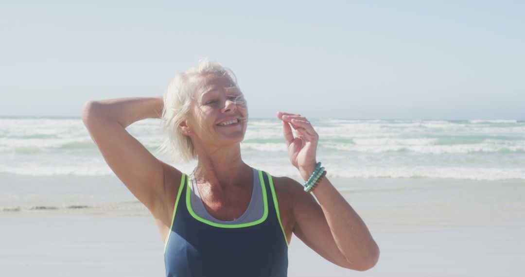 Smiling Senior Woman Embracing Active Lifestyle at Beach - Free Images, Stock Photos and Pictures on Pikwizard.com