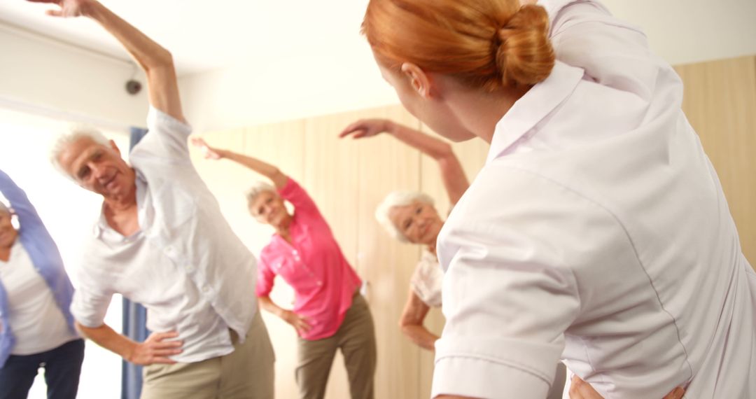 Senior Group Exercise Class with Instructor Leading Stretching Routine - Free Images, Stock Photos and Pictures on Pikwizard.com