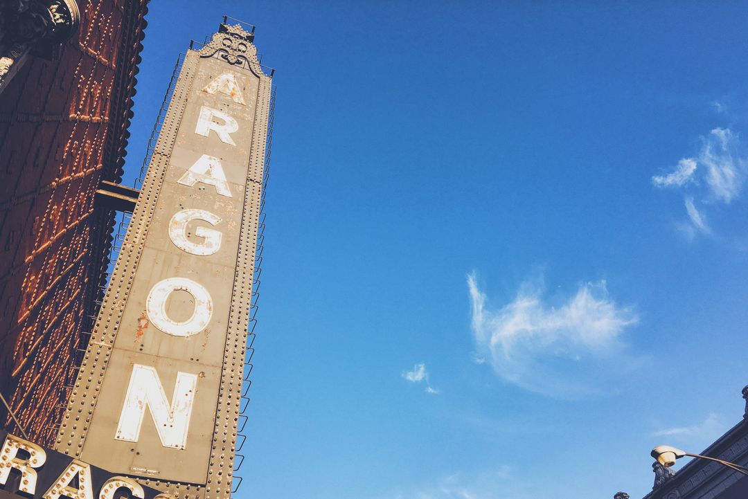 Vintage Aragon Theater Sign Under Clear Blue Sky - Free Images, Stock Photos and Pictures on Pikwizard.com