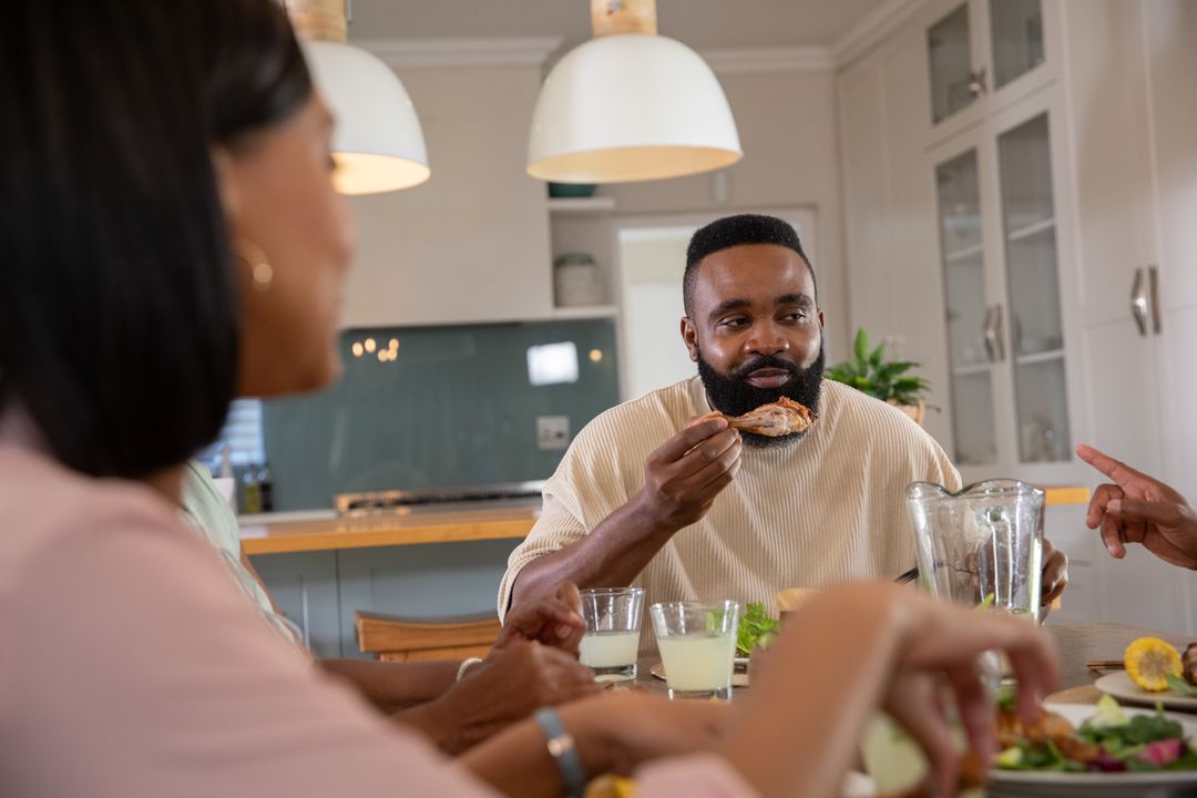 Diverse Friends Enjoying Meal in Modern Kitchen