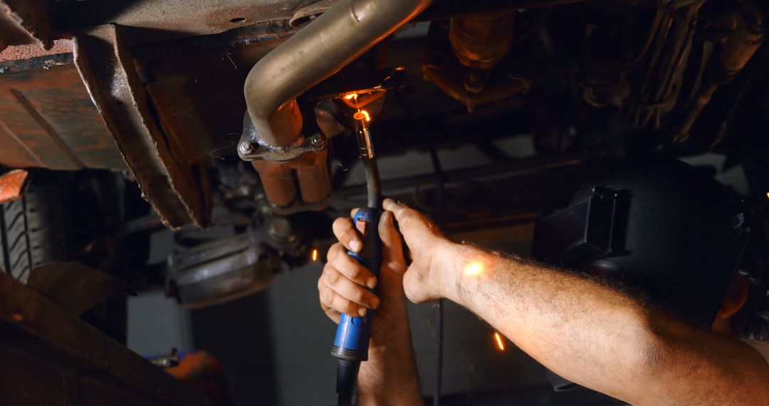 Mechanic Repairing Car Exhaust with Torch Equipment - Free Images, Stock Photos and Pictures on Pikwizard.com