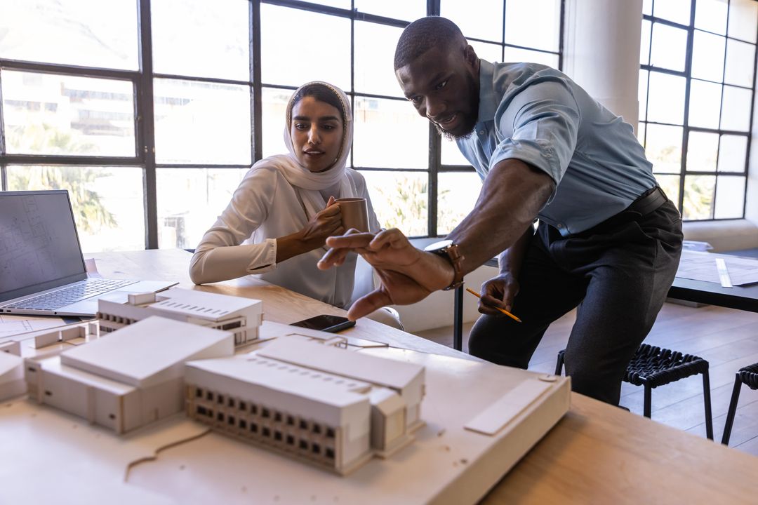 Architects Collaborating Over Model in Office Environment