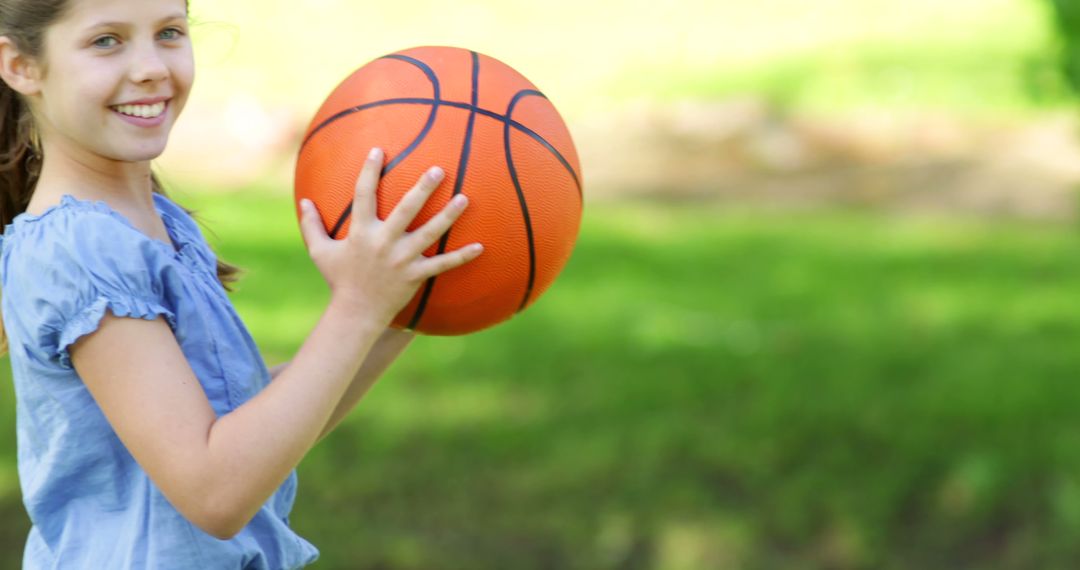 Girl Enjoying Basketball in Sunny Park