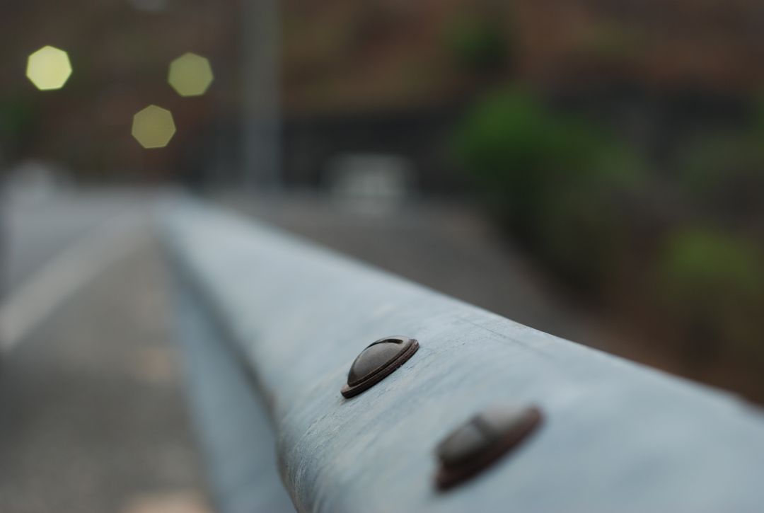 Close-up of Metal Guardrail on Roadside with Bokeh Background - Free Images, Stock Photos and Pictures on Pikwizard.com