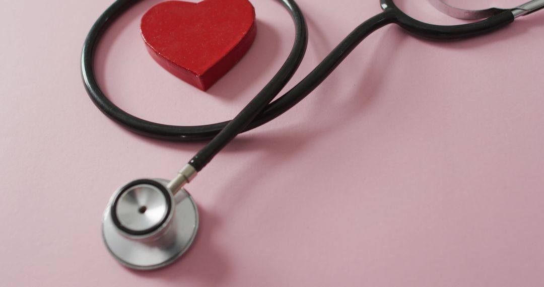 Stethoscope with Red Heart on Pink Background for Love and Health Concept