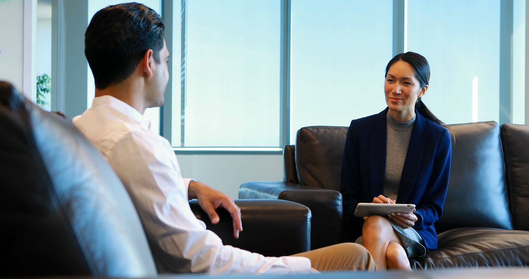 Diverse Professionals Engaging in Business Conversation in Modern Office - Free Images, Stock Photos and Pictures on Pikwizard.com