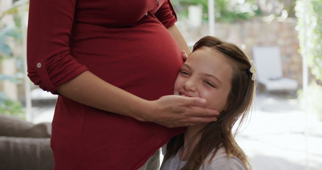 Pregnant Woman Embracing Smiling Daughter at Home - Free Images, Stock Photos and Pictures on Pikwizard.com