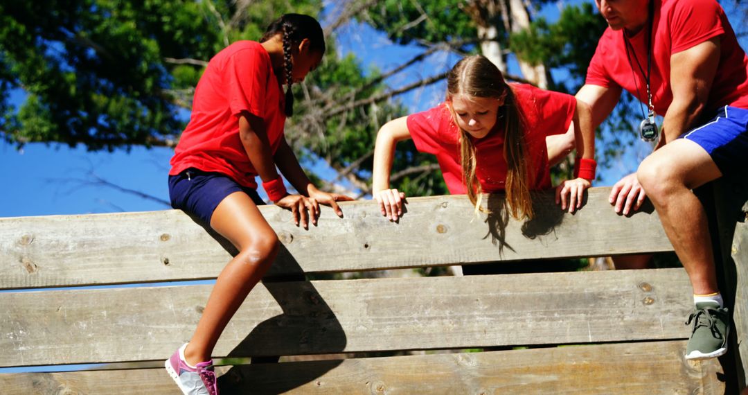 Children Climbing Obstacle Course Wall with Coach Assistance - Free Images, Stock Photos and Pictures on Pikwizard.com