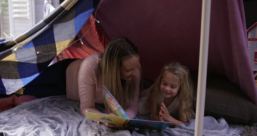 Mother and Daughter Reading in Cozy Blanket Fort - Free Images, Stock Photos and Pictures on Pikwizard.com